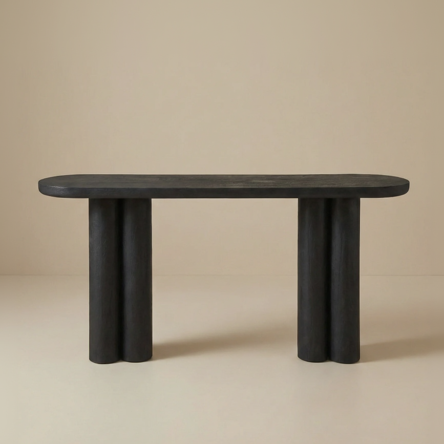 Daro console table in a matte black wood finish, highlighting its sculptural triple-column base and modern oval silhouette.