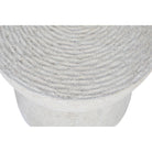 Top-down view of the Dune side table highlighting the concentric spiral pattern and rough concrete texture.