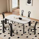 Top view of Eclipse Elegance dining table with sintered stone top and black curved legs styled with boucle dining chairs