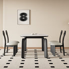 Front view of Eclipse Elegance dining table with sintered stone top and sculpted black wood legs styled with boucle dining chairs