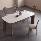 Top view of Eclipse Elegance dining table with sintered stone surface and walnut curved legs surrounded by boucle dining chairs