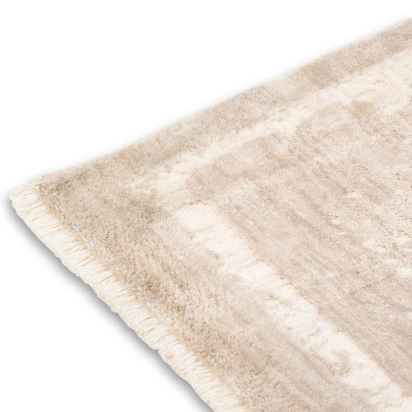 Angled view of the corner on the Elara distressed soft-touch rug highlighting its vintage faded pattern.