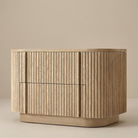 Elias Oak Night Stand with fluted drawer front shown in a clean beige studio setting