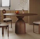 Evelyn walnut round dining table with sculptural pedestal base in modern kitchen