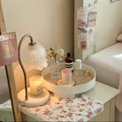 Glass Flower Candle Warmer Lamp on a cozy bedside table with lit candle and decorative accessories.
