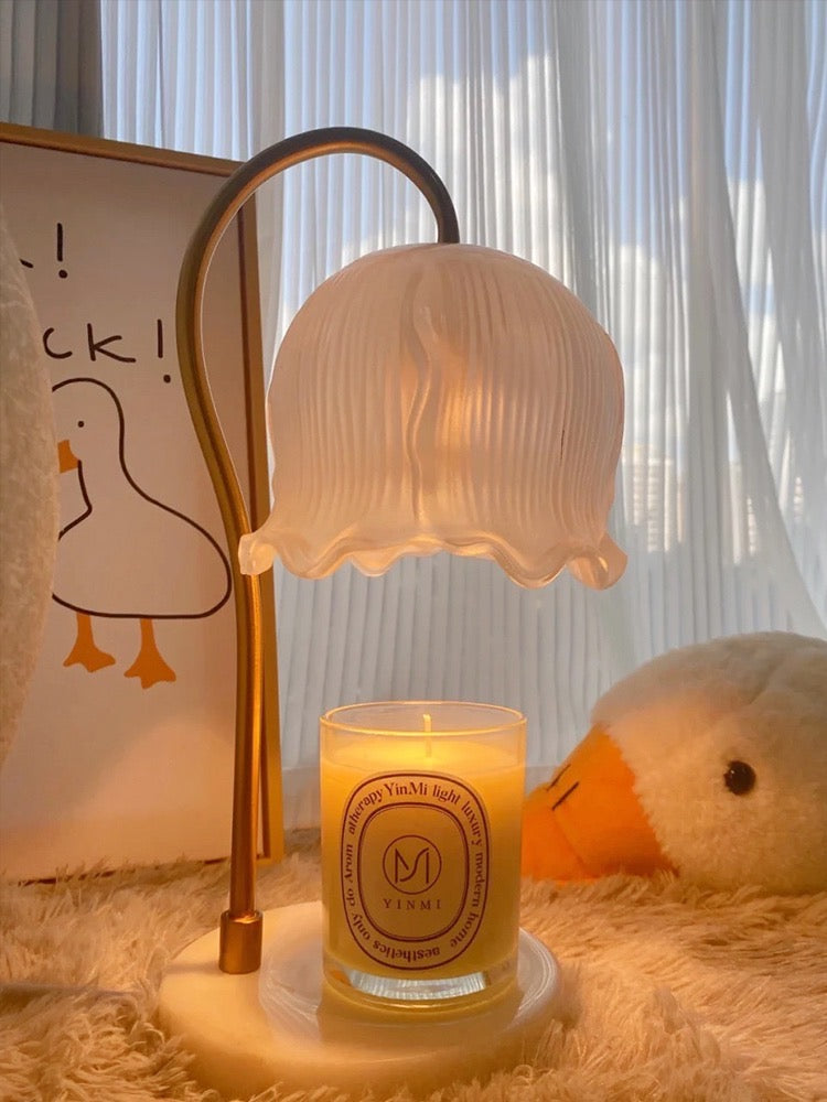 Glass Flower Candle Warmer Lamp on a cozy surface with a lit candle and soft plush decor.