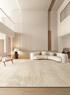 Grace Rug styled in a modern neutral living room with curved cream sofa, wooden accents, and soft beige textured pattern