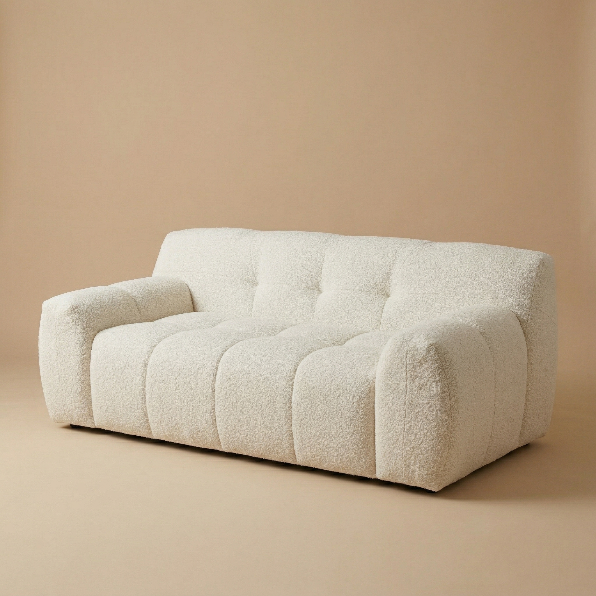 Angled studio shot of the Gummy sofa emphasizing the depth of its cushions and its modern, sculptural form.
