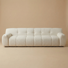 Full front studio view of the Gummy sofa showcasing its unique channeled block design and cream bouclé upholstery.
