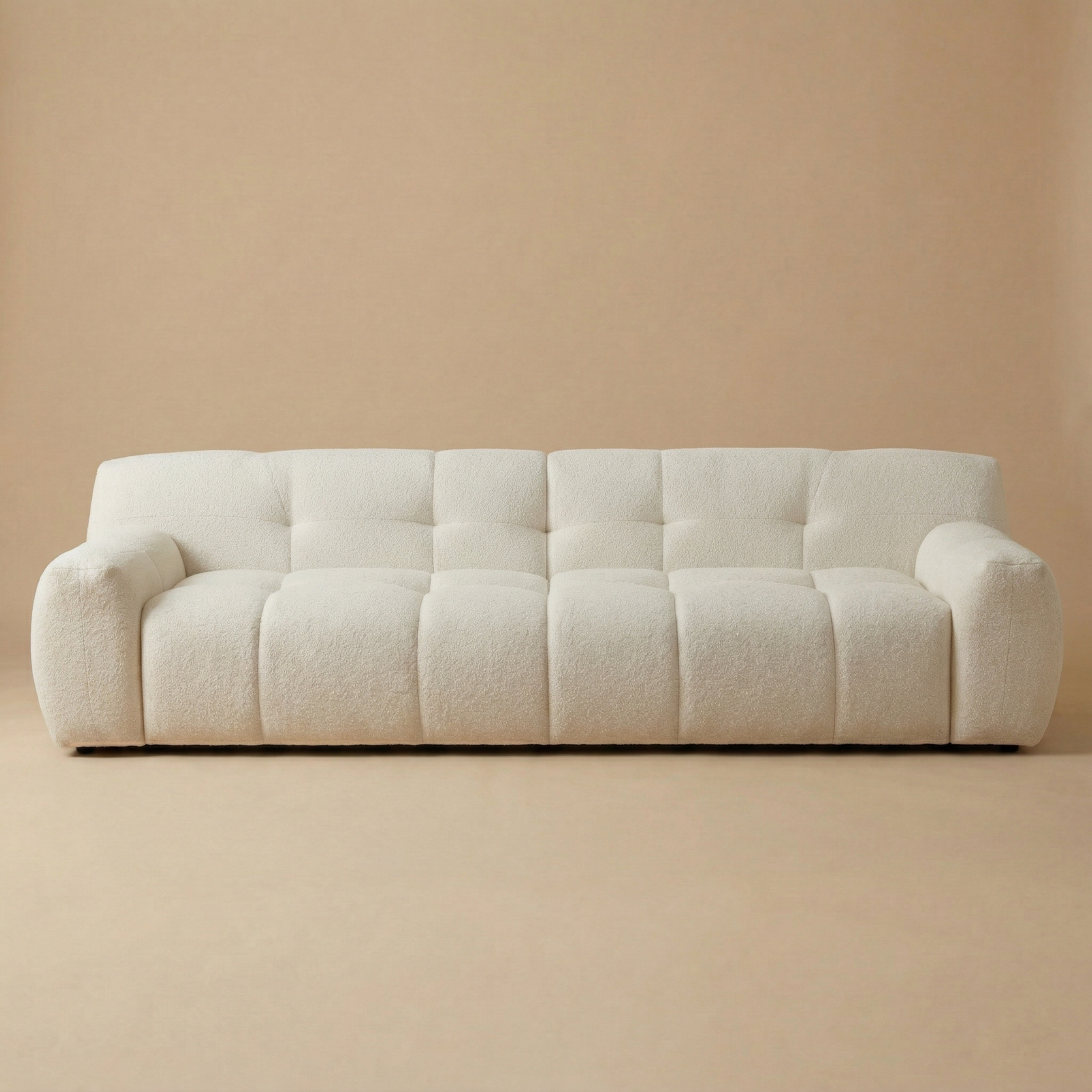 Full front studio view of the Gummy sofa showcasing its unique channeled block design and cream bouclé upholstery.