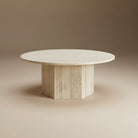 Harmony Travertine Coffee Table with round top and geometric pedestal base displayed in a neutral studio setting