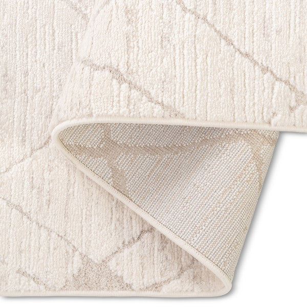 Folded corner of the Harper modern trellis rug showcasing its soft textured surface and durable woven backing.