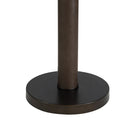 Close-up of the round dark bronze base and textured pole of the Harrison floor lamp.