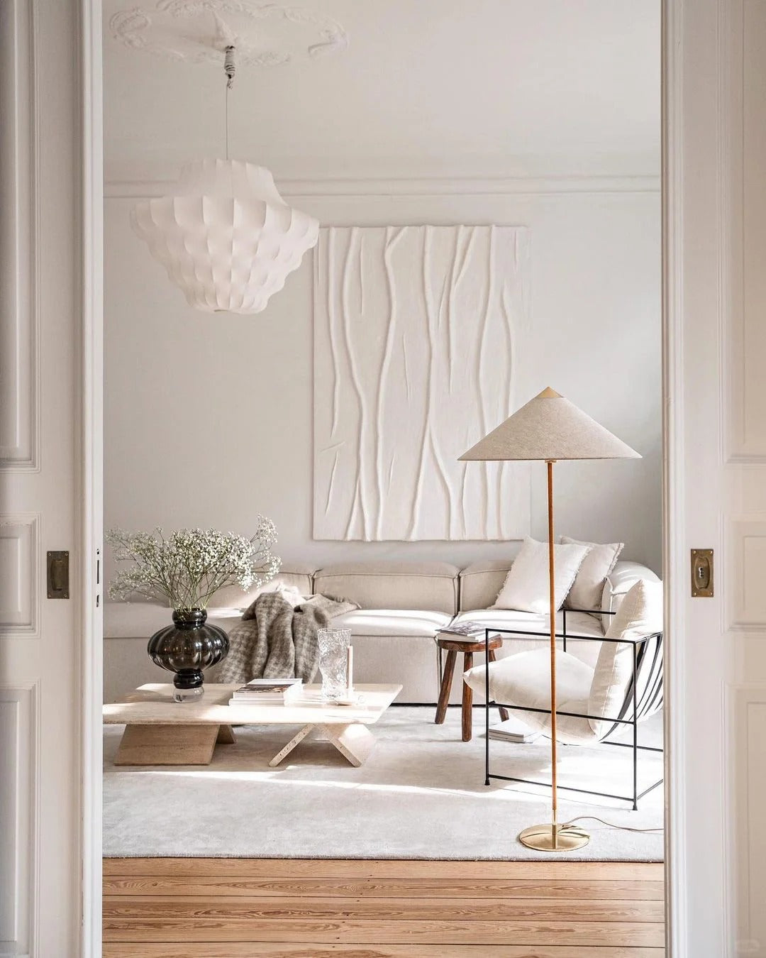 Horizon Shade Floor Lamp with brass base and linen cone shade in a minimalist neutral living room with cream sofa and wood accents