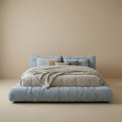 Modern Italian cloud bed frame in blue linen with a soft, unstructured silhouette and low profile design.