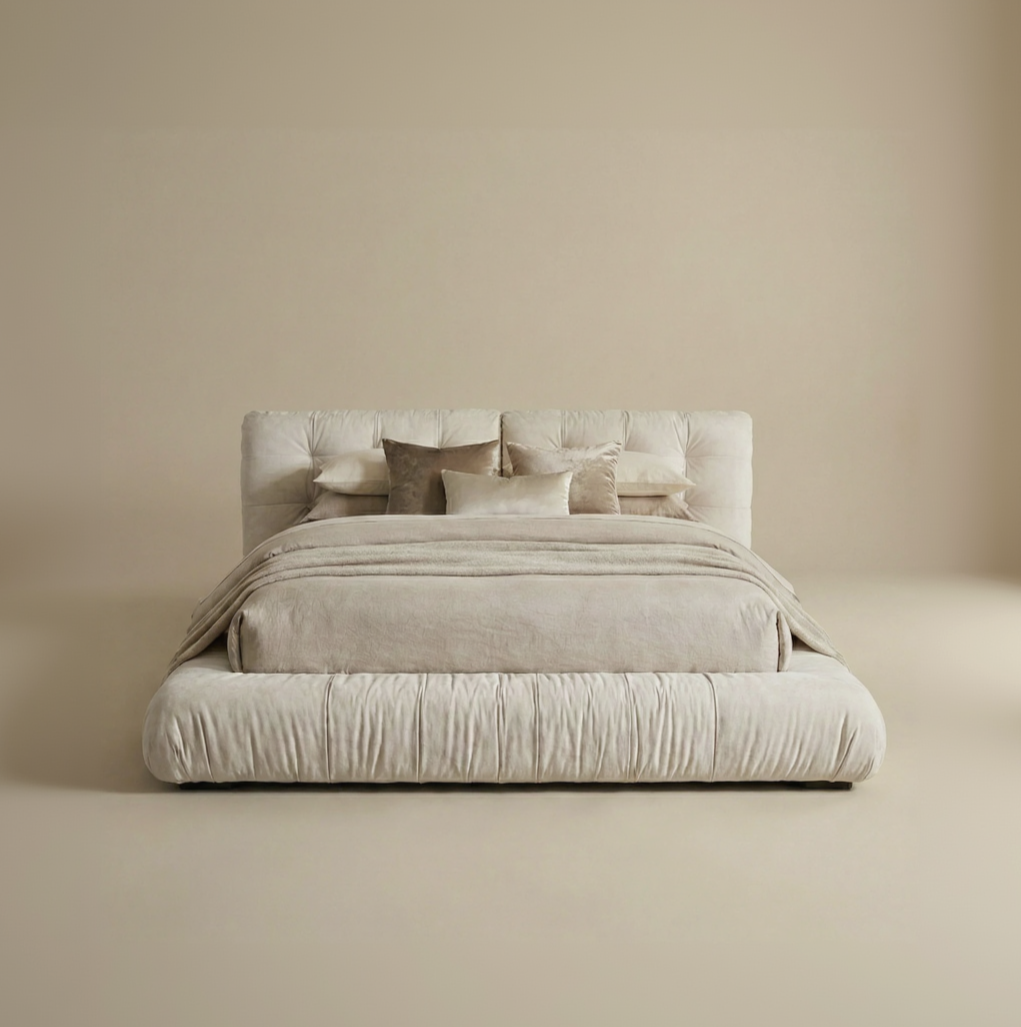 Italian-style cloud bed in cream velvet featuring a plush square-tufted headboard and gathered fabric side rails.