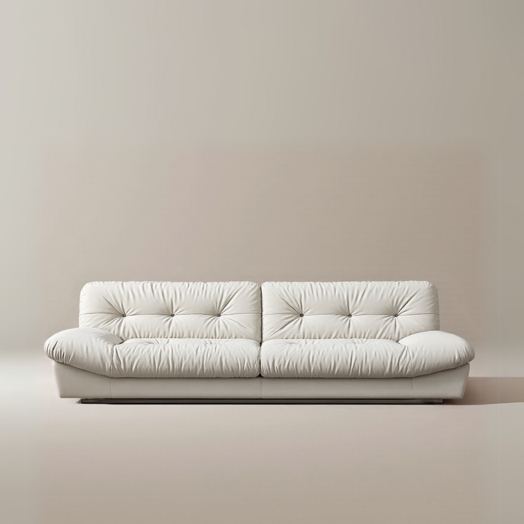 Italian-style Cloud Sofa in cream upholstery with deep tufted cushions and low modern silhouette on a beige studio background