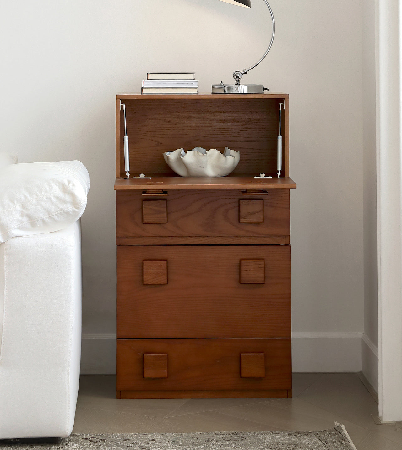 Jasper Modular Sideboard with top compartment open, showing interior storage, styled beside a sofa in a modern living room.