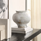 Keros Vase styled on a black shelf with stacked books and neutral decor in soft natural light