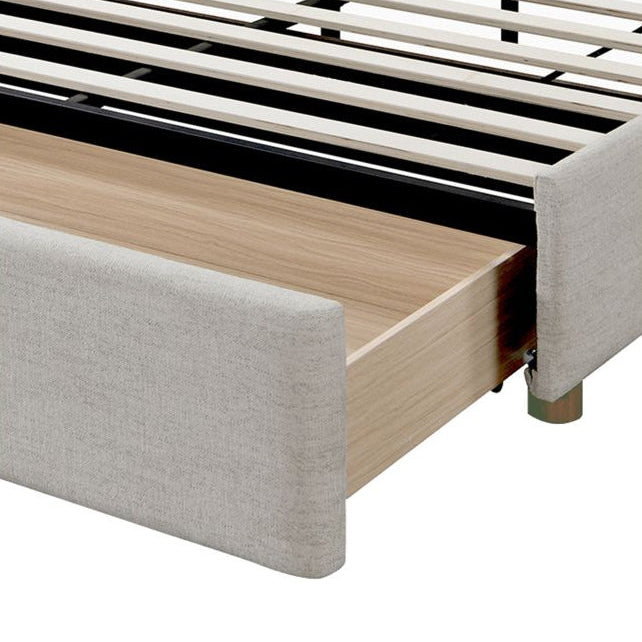 Close-up of Lena Storage Bed pull-out drawer showing wood interior and upholstered front, on a white studio background