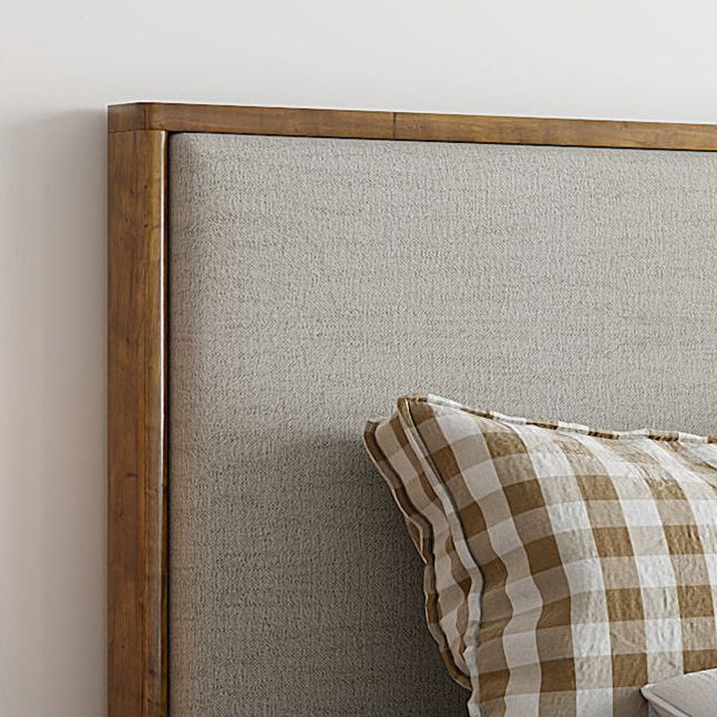 Lena Storage Bed headboard close-up showing upholstered fabric and wood frame against a light wall background