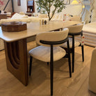 Linen Ash Wood Dining Side Chair in showroom setting beside wooden dining table