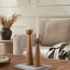 Liora Candle Duo displayed on coffee table in cozy living room with neutral tones, wooden accents, and soft beige decor"