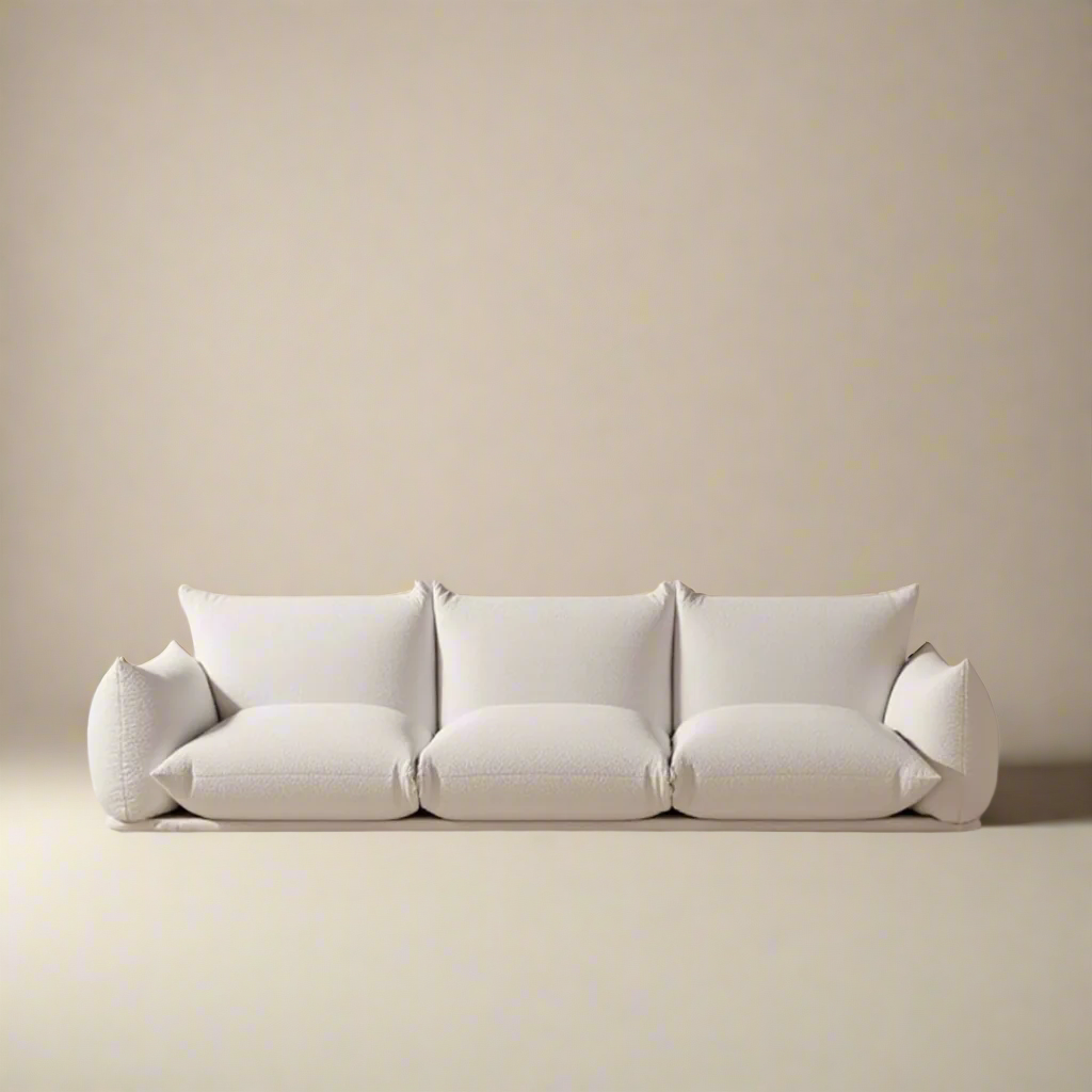 Loaf Bread Sofa in white fabric with plush cushions and pillow-like arms against neutral studio background