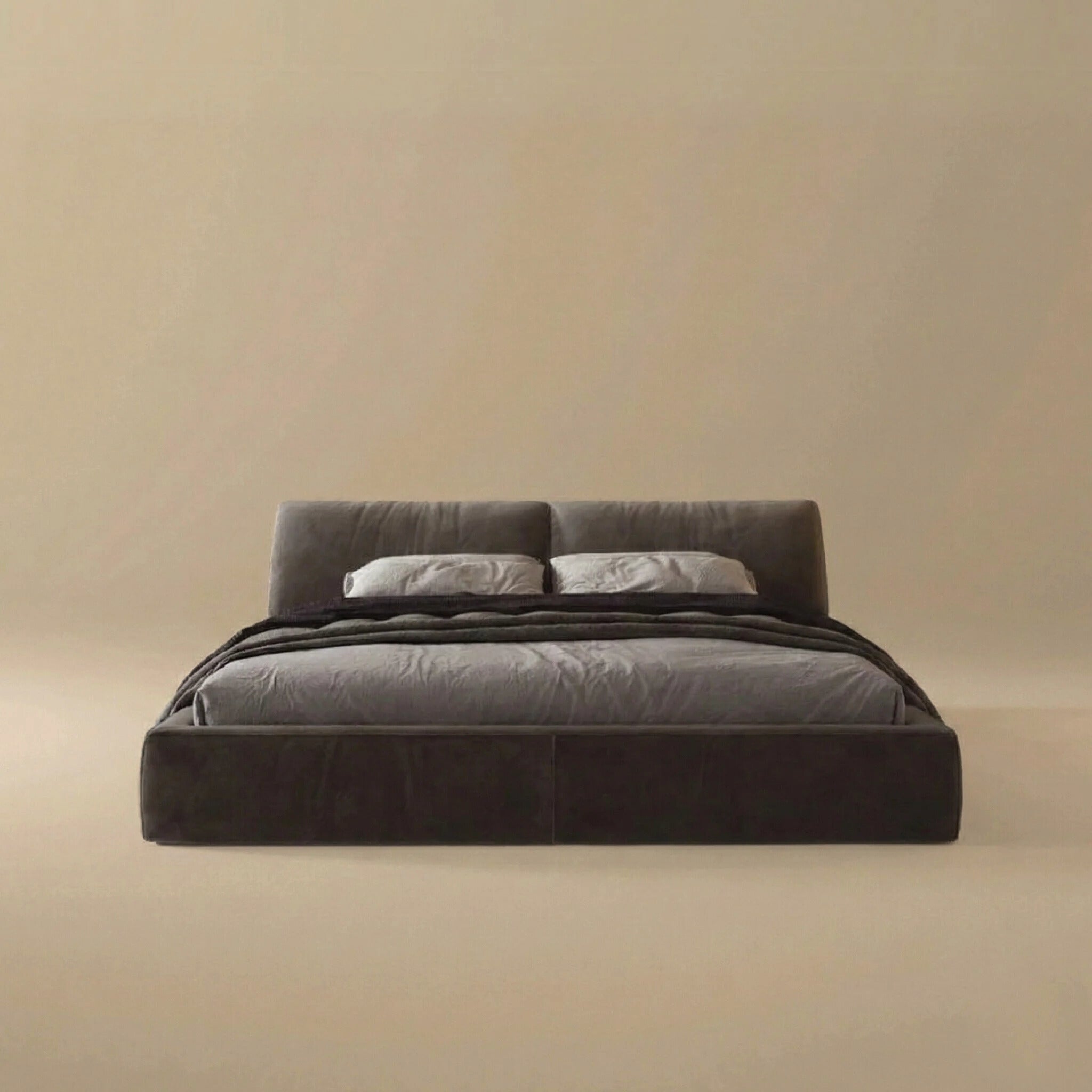 Front view of the Luxury Elephant Ear bed featuring oversized pillow headboard cushions and a low profile fully upholstered frame in dark grey velvet.