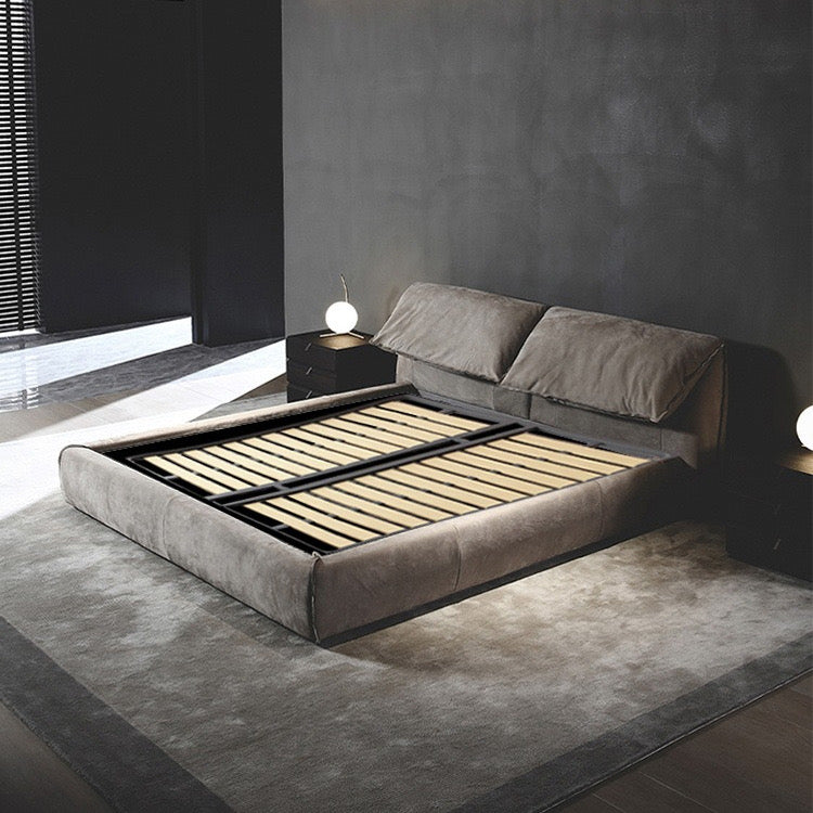 Luxury Elephant Ear Bed Frame in grey velvet with slatted base displayed in modern bedroom with dark wall and soft lighting