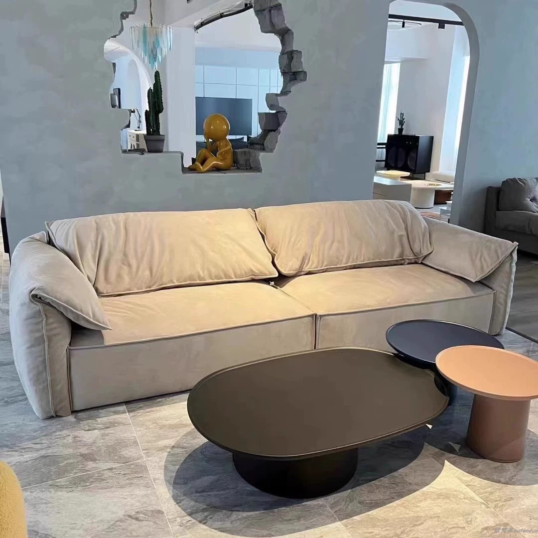 Luxury Elephant Ear Sofa in matte champagne ultra suede with plush cushions and relaxed arms in a modern living room