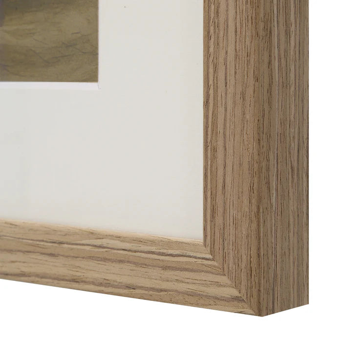 Macro close-up of the natural light wood frame and white matting on the Margot vessel wall art.