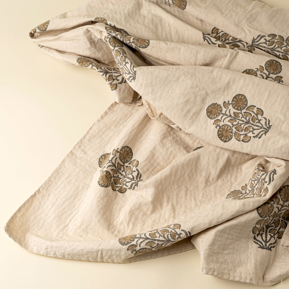 Beige fabric with floral embroidery on a beige background