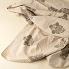 Beige fabric with floral embroidery on a beige background