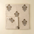 Set of beige towels with brown floral patterns on a beige background