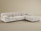 Mario Bellini Sofa in white bouclé fabric arranged in an L-shaped sectional with deep tufting and plush cushions on beige background