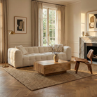 The Marshmallow sofa styled in a warm living space with a block wood coffee table, jute rug, and mid-century plywood chair.
