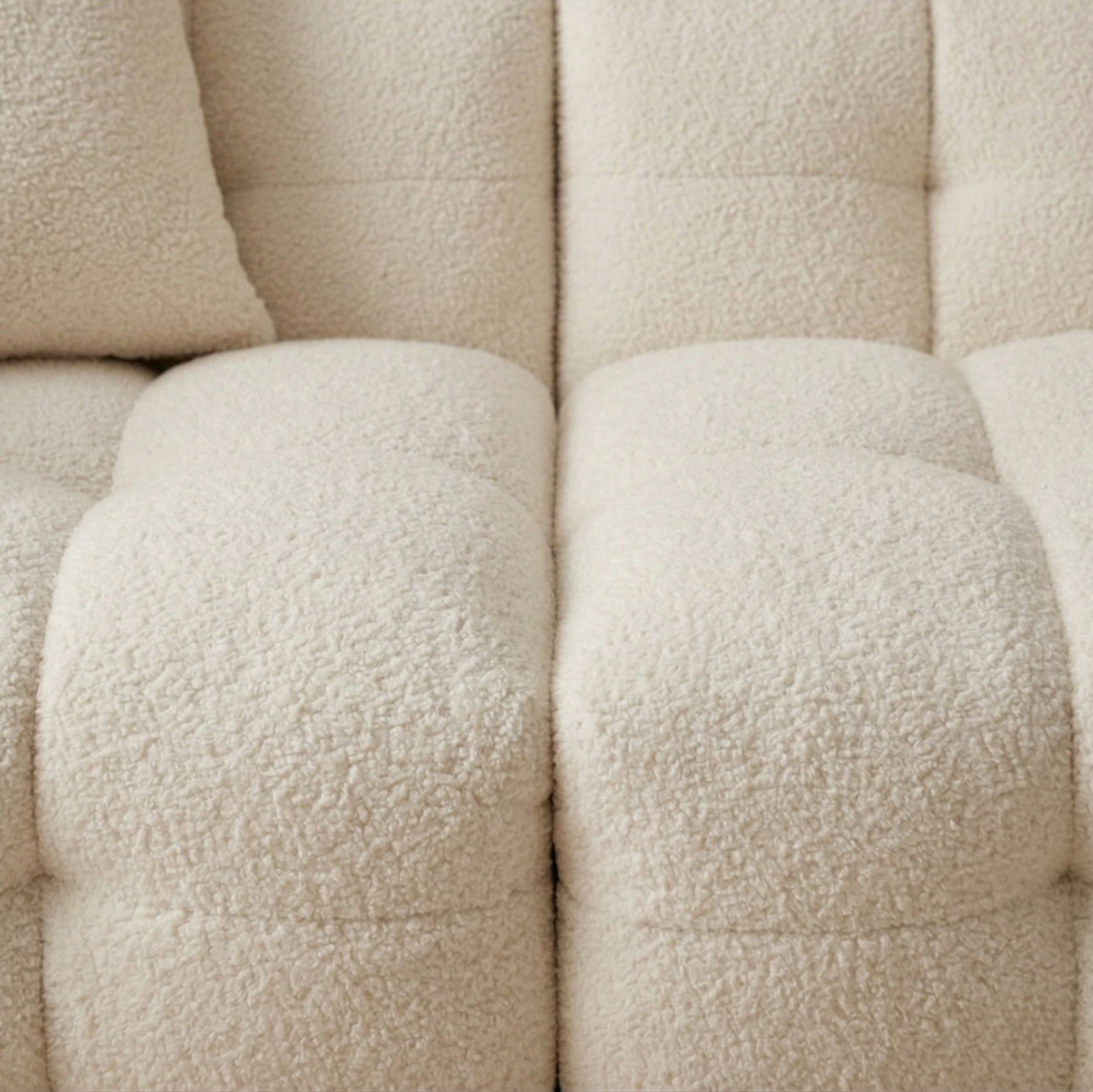 Macro close-up of the Marshmallow sofa highlighting the high-quality bouclé texture and the deep, precise quilted tufting.