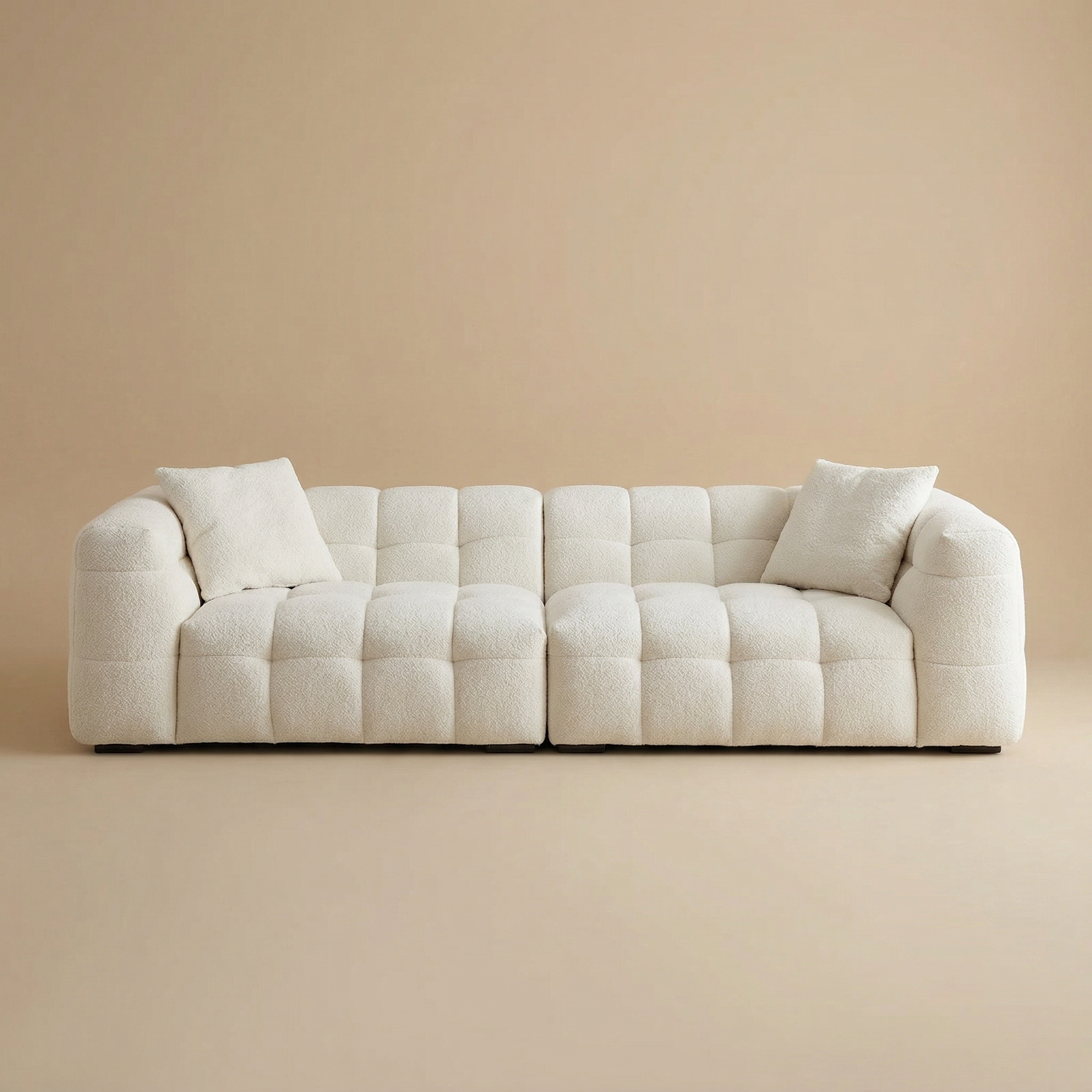 Straight-on studio view of the Marshmallow sofa featuring a grid-tufted design and cream bouclé upholstery.