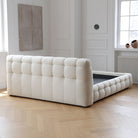 Marshmallow Puff Bed showing plush tufted backrest and frame in white boucle fabric placed in a bright modern bedroom