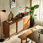 Mid-Century Rattan Craft Sideboard with sliding cane doors and wood drawers in a modern dining room.