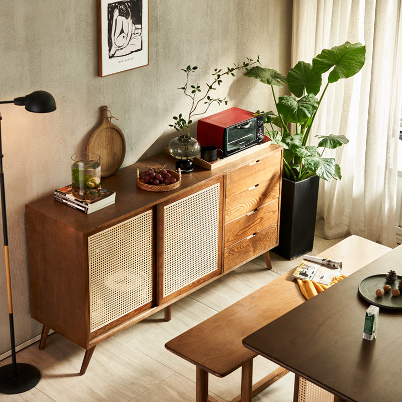 Mid-Century Rattan Craft Sideboard with sliding cane doors and wood drawers in a modern dining room.