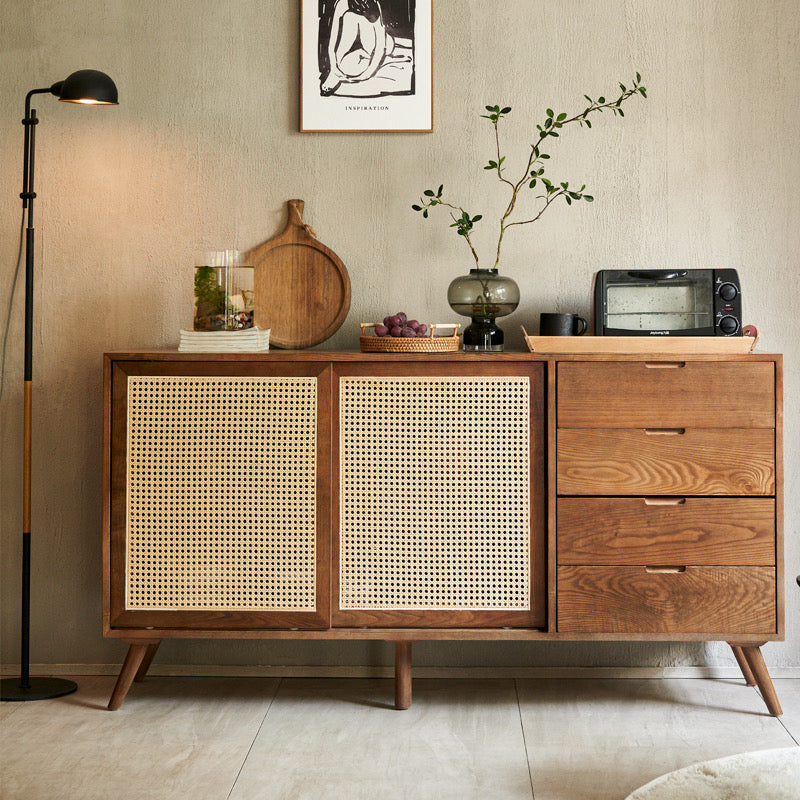 Mid-Century Rattan Craft Sideboard with sliding cane doors and wood drawers in a cozy modern dining space.