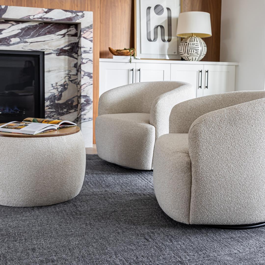 Two Milo swivel chairs styled with a matching round bouclé ottoman in a contemporary home setting.