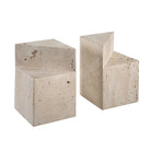 Angled studio shot of the geometric travertine bookends, showcasing the unique stepped architectural cutouts and porous stone surface.