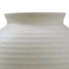 Close-up of Nara Ceramic Vase showing the smooth ribbed texture and curved neck in matte ivory finish