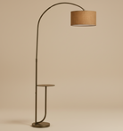 Noir Tray Curve Lamp featuring a curved metal stand with built-in side tray and warm fabric shade on beige background