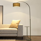 Noir Tray Curve Lamp positioned beside a beige sofa, featuring a built-in tray and warm ambient lighting in a modern living room