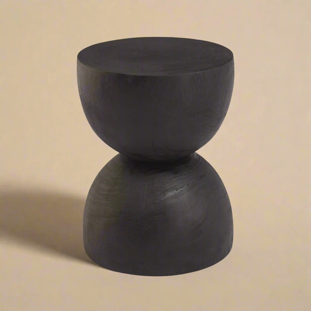 Onda accent table featuring a sculptural hourglass silhouette in matte black solid wood.