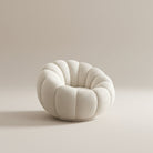 Ophelia Bouclé Swivel Accent Chair with a rounded sculptural shape, upholstered in soft bouclé on a beige studio background